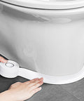 TOUSEA white waterproof self-adhesive sealant tape applied to toilet base, side view