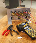 Top Shelf Portable Color Label Maker Kit With Rugged Carrying Case And Fast Swap Battery For Snappy Wire Tagging And Circuit Board Markers Easy Peasy Setup Delivers Knockout Prints Everyday on a workspace with wires.