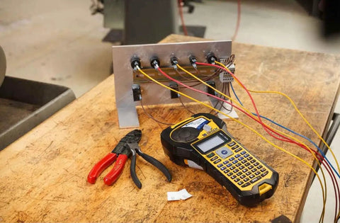 Top Shelf Portable Color Label Maker Kit With Rugged Carrying Case And Fast Swap Battery For Snappy Wire Tagging And Circuit Board Markers Easy Peasy Setup Delivers Knockout Prints Everyday on a workspace with wires.