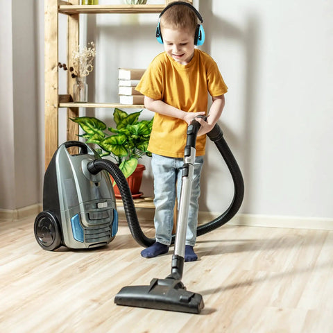Child vacuuming wearing Four Pack Kids Ear Protection Earmuffs Adjustable Noise Reduction 27NRR Noise Cancelling Earmuffs, yellow shirt.