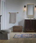 Eclectic 24 Inch Towel Bar In Vibrant Brushe Finish mounted on bathroom wall with towel, complementing modern transitional decor