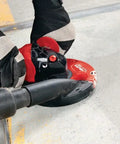 Professional Grade 1300W 230V Angle Grinder Featuring 125MM Disc Size in use on concrete surface for fast metal cutting.