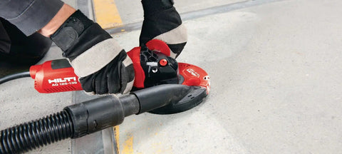 Professional Grade 1300W 230V Angle Grinder Featuring 125MM Disc Size in use on concrete surface for fast metal cutting.