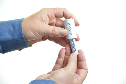 Person holding AA battery from All In One Power Pack Battery Kit With 8 AA And 2 AAA NiMH Rechargeables.