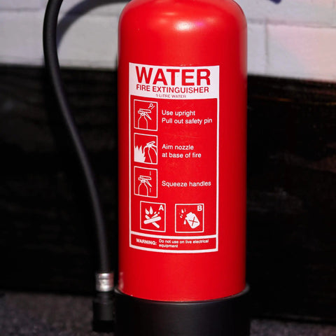 Rad Miniature Resin Fire Extinguisher 1/4 Scale Replica featuring sharp printed safety instructions on a red prop.