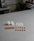 32Piece Plasma Cutter Consumable Kit with nozzles, electrodes, ceramic rings arranged on a workshop table for PT31 LGK40 CUT40 CUT50 CT312 CT418 CT520 SUPER200P.