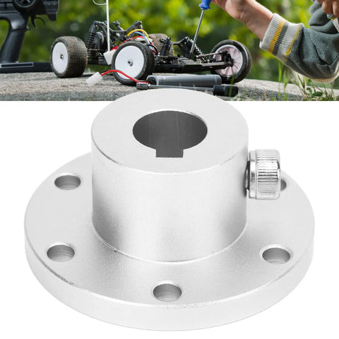 Aluminum Flange Coupling For RC Models 14mm Shaft connector with locking key, shown in front of an RC model vehicle in use.