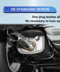 Automotive exhaust muffler with tailpipe visible undercarriage beside wheel; silver metal.