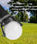 Close-up of foldable golf ball retriever for putter with suction cup grabber and ball on green grass.
