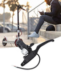 Electric Scooter Left Hand Brake Lever With Bell Hall Effect Waterproof Aluminum Alloy Handle Controller Replacement Brake Lever For Xiaomi E Scooter Durable Non Slip Quick Install Enhanced Braking Power And Reliable Performance Heavy Duty shown with a parked e-scooter and a person seated nearby.