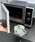 4 Pack Oven And Cabinet Childproof Locks For Kitchens ABS Plastic Safety Latches next to an open microwave on kitchen counter