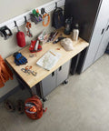 Garage setup with Heavy Duty Welded Steel Hooks For Garage Wall Storage, 8 Pack, holding coats and tools, above a workbench.