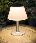Go To Solar Table Lamp For Outdoor And Indoor Use With 3 Lighting Modes Eye Caring LED Waterproof Cordless Desk Lamp on a patio table