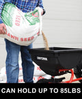 Man pouring lawn seed into 85 Lb Tow Behind Broadcast Spreader With Direct Rod Control Wide 4 To 8 Ft Spread Heavy Duty Frame