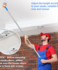 Say No To Wobbly Ladders With This Smart Smoke Detector Removal Tool Featuring An Adjustable Reach Pole Stretching Up To 10 Feet For Easy Ceiling Disassembly And Hassle Free Maintenance. User adjusting the 10 ft extendable pole to remove a smoke alarm.