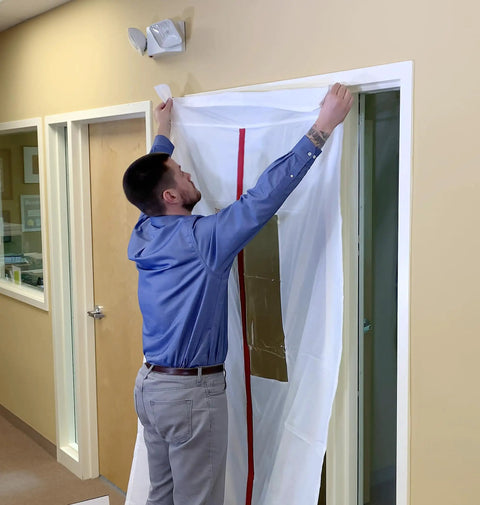 Person installing ZipDoor ZDM Magnetic Door Kit with self-closing magnets for dust barriers, fits 48x87 inches, white polyester.