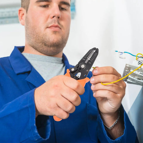 Man using Tough As Nails Wire Stripper Pliers With Cushioned Safety Lock And Stainless Steel Blades on electrical wire.