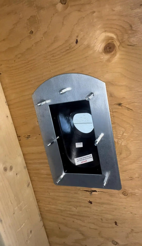 Inside Install Roof Flange For Pipe Flashing No Climbing Needed Works With Architectural And Conventional Shingles Handles Flat To 12 To 12 Pitch All Weather Install Even In Snow Patented Leak Proof Roofing Solution, shown installed on wooden roof from inside.