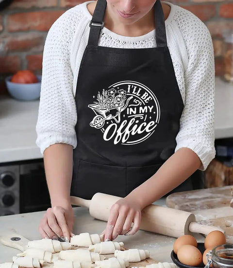 "I'll Be In My Office Garden Lover Apron For Women And Men" worn while baking, shows adjustable fit, waterproof polyester cotton.