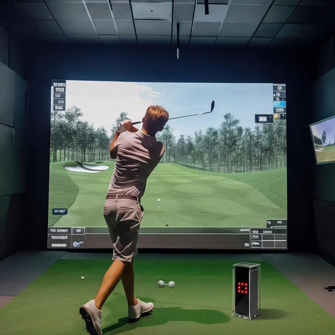 Golfer practicing indoors with simulator, Square Golf Launch Monitor Protective Shield Case in clear acrylic on floor.