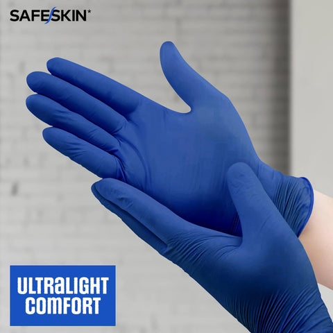 Safeskin blue nitrile disposable gloves on hands; close-up, large size, 2.0 mil, powder-free, latex-free