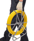 Person carrying Fiberglass Fish Tape 6Mm 425ft Duct Rodder Cable Puller for Electrical Wiring with steel wheel stand.