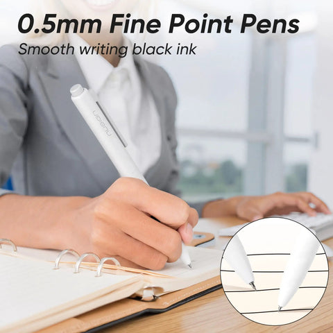 Person using a Gel Pens Set 12 Pack 0.5mm Quick Dry Black Ink Fine Point For Journaling And Note Taking at a desk