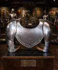 Medieval Iron Gorget and Spaulders Shoulder Armor Set for Reenactors on display, natural steel finish, museum setting.