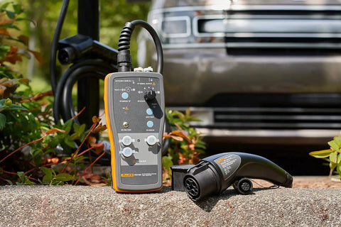 Slick Heavy Duty Type One Electric Vehicle Charging Station Diagnostic Adapter For Testing Level 1 And Level 2 Ac Systems With Gfci And Ground Safety Checks Plug Right In resting on a stone surface.