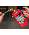 Eco-Friendly Non-Aerosol Reusable Liquid Sprayer Powered By Your Compressor, 80-150 PSI, red canister in hands