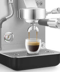 Next Level Semi Pro Espresso Machine Featuring 15 Bar Pump Pressure And Triple Thermoblock Heating For Rock Solid Temp Control And Strong Steam Wand Pulling Real Deal Barista Shots Daily In Glossy Black with espresso pouring into a glass.