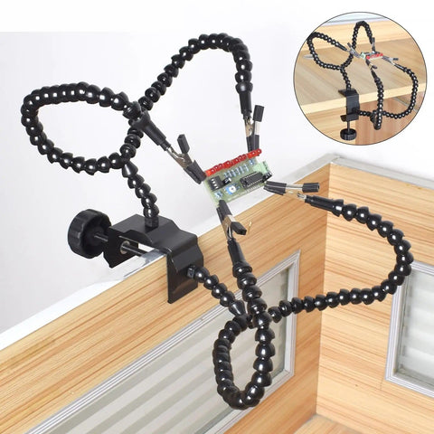 Third Hand Soldering Station with Adjustable Gooseneck Arms holding circuit board, clamped to wooden desk edge.
