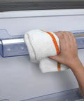 Person using a 60 Pack 16 By 19 Inch Terry Bar Mop Rag for Cleaning Absorbent and Durable Cotton Cloths on a kitchen appliance.