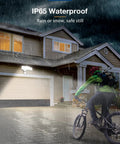 Cyclist in rain with 40W Remote LED Security Light With Motion Sensor, 4000 Lumens on house, IP65 Waterproof Outdoor Lighting