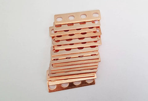 Top Shelf 16 Piece Purple Copper Battery Bus Bar Connection Plates For 5.5 6.2 And 6.9 Ah Lithium Cells stacked for wiring.