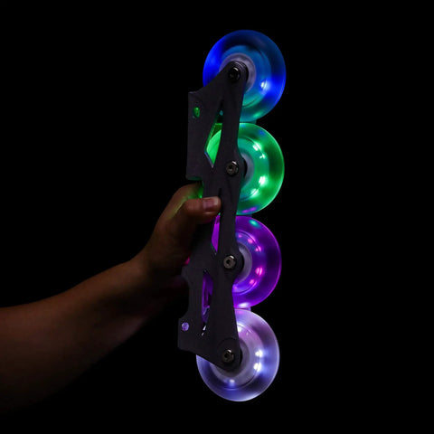 Hand holding frame with Glowrider 92A Inline Skate Wheels With Built In Magnetic LED Lights 80mm, showcasing UV purple glow.