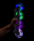 Hand holding Glowrider 92A Inline Skate Wheels With Magnetic LED Lights And Bearings, 80mm lit wheels for night rides