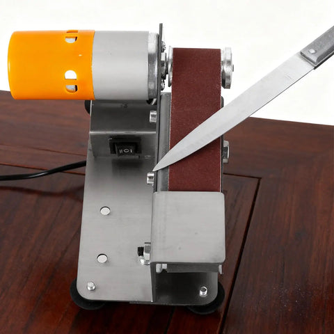Pro Grade Mini Belt Sander And 15 Degree Electric Spindle Knife Sharpener featuring a knife being sharpened on its belt.