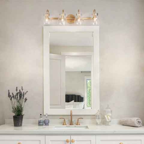 Gold Modern Bathroom Vanity Lights Over Mirror With Four Clear Glass Shades above a white vanity