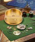 Watch Movement Holder With Durable Aluminum Alloy Base Repair Stand next to watch components and tools on a green mat