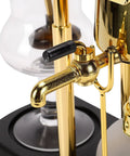 Artisan Manual Siphon Coffee Maker Featuring Sturdy Heatproof Glass Carafe showing gold faucet and heatproof glass elements.