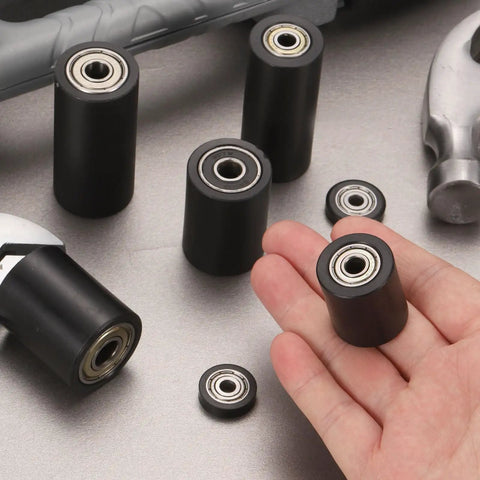 Close-up of 4 Pack Plastic Roller Wheels With Bearings For Conveyor Systems And Warehouse Carts, Guiding Belt Idler Rollers, held in hand