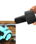 Vacuum Hose Adapter Two And A Half Inch To One And A Quarter Inch For Shop Vacuums Wet And Dry Black held near a vacuum cleaner