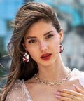 Dope Poker Suit Dangle Drop Earrings Featuring Bold Grid Card Pattern worn by a woman with a chain necklace and stylish blouse.
