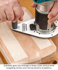 Knockout Performance Phenolic Trim Router Base for Compact Palm Routers on wood, showcasing stability and grip during routing.