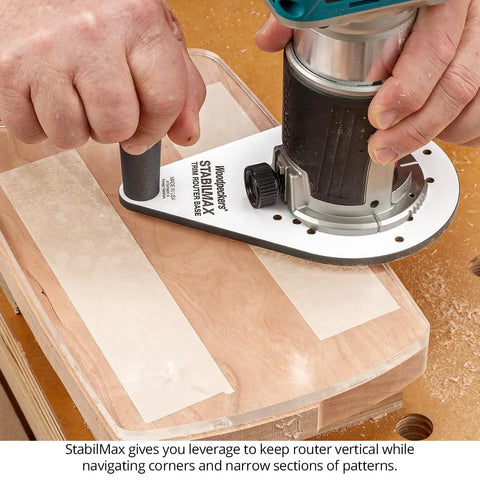 Knockout Performance Phenolic Trim Router Base for Compact Palm Routers on wood, showcasing stability and grip during routing.