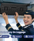 20-inch black aluminum-framed zipperless hard-shell carry-on luggage loaded into airline overhead bin by a flight attendant.