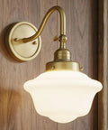 SongCiLT Vintage Sconce Wall Lighting with Milk White Glass Shade on wooden wall, featuring adjustable brass arm and elegant design.