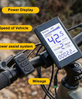 Waterproof Dope Electric Bike LCD Display Meter With 5 Pin Connector showing speed, power, and mileage on bicycle handlebar.