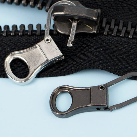 Close-up of Tiny Zipper Pulls Set For Clothes And Bags, Detachable Replacement Tabs For Small Hole Zippers, 4 Pack In Gunblack